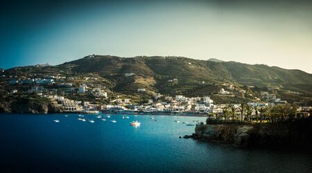 Aerial view of island with coastal town and mountain, Crete, Greece