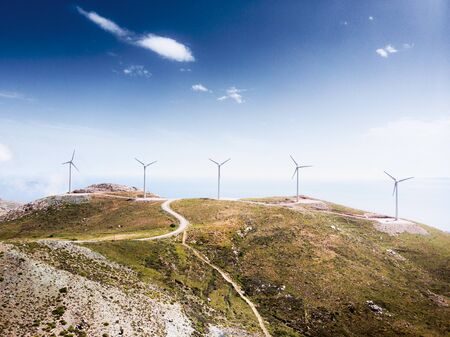 Wind field with mountain pass against skyの写真素材