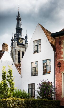 Residential building and historic clock tower, Leuven, Belgiumの写真素材