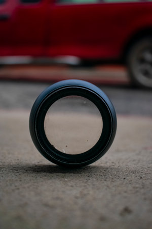 Camera lens on the floor in the parking lot. Selective focus.