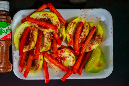 Stuffed peppers with paprika and chili sauce in a plastic box