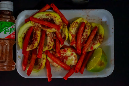 Slices of red and yellow peppers on a white plate.