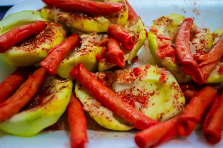 Apples stuffed with paprika and paprika on a white plateの写真素材