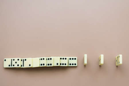 Concept of social distancing explained with dominoes, with some of them fallen but others spread enough to not fall, top viewの写真素材
