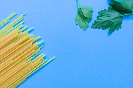 spaghetti and rosemary over a blue backgroundの写真素材