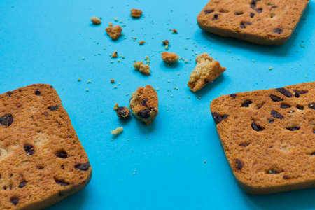 Cookie and some crumbs on a blue backgroundの写真素材