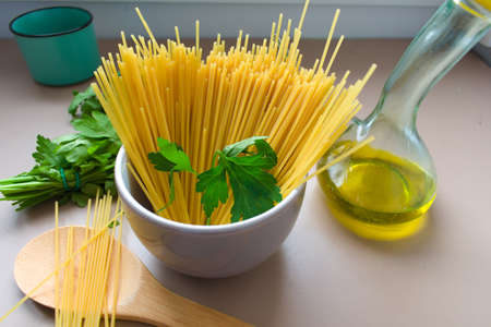 Raw spaghetti, oil and rosemaryの写真素材