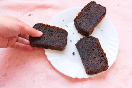 Taking a piece of homemade blueberry cake from a plateの写真素材