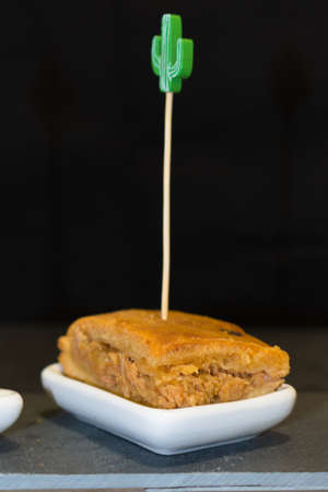 A pincho of galician pie over a black backgroundの写真素材