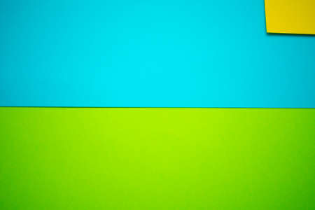 Sky blue and grass green cardboard background, with a piece of yellow cardboard on the top, giving...