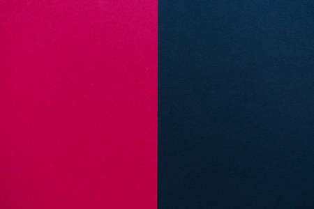 Cherry red and black cardboard background, with a vertical division, red on the left and black on the rightの写真素材