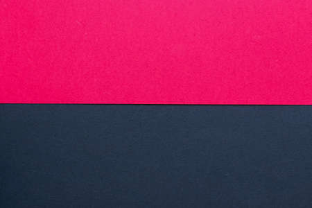 Cherry red and black cardboard background, with a horizontal division, red on the top and black on the bottomの写真素材