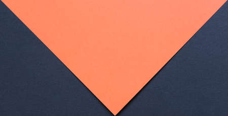 orange and black cardboard background, with the black part forming two triangles on the bottomの写真素材
