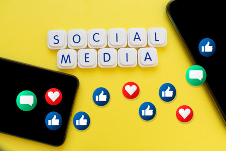 Social media letters, with two smartphones and icons of thumbs up, hearts and message float.の写真素材