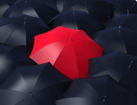Red umbrella outstanding from black umbrellas の写真素材