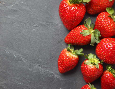 Strawberry background on stone slateの写真素材