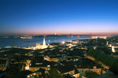 view from the castle of the city Lisbon, you can see the tagus river, the bride 25 april, the Monument at jesus crist and the bigest christmas tree of the europe の写真素材