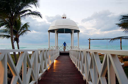 young men looking at the ocean inside of a small chapel, conceptual dream の写真素材
