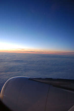 top view from the wing of a airplane at sunrise 