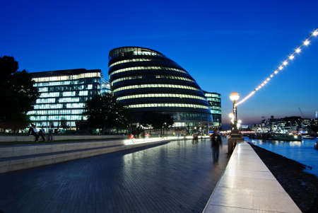 city hall at dusk with people in the sidewalkの写真素材