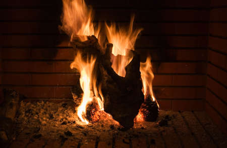 fireplace, wood with the shape of a hearth on fireの写真素材
