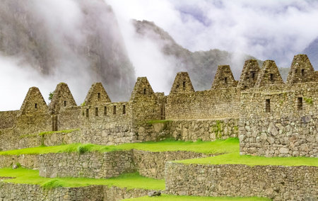 Architectural detail of the wonderful Inca Machu Picchu, with the Huayna Picchu in the misty background, Peru.の写真素材
