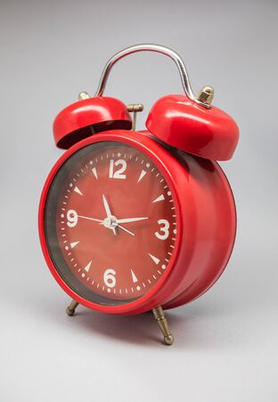 A clock and retro alarm clock, old model known for its sound.の写真素材