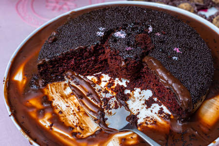 Dark vegan chocolate cake, with party background.の写真素材