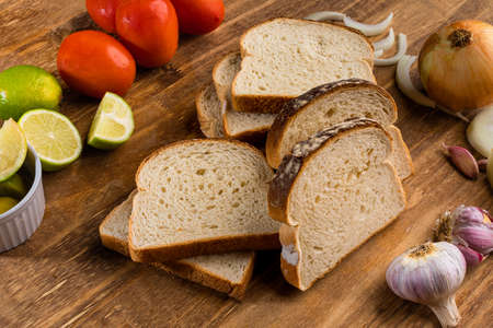 Sliced white bread with wheat flour on a wooden table. Called loaf of bread.