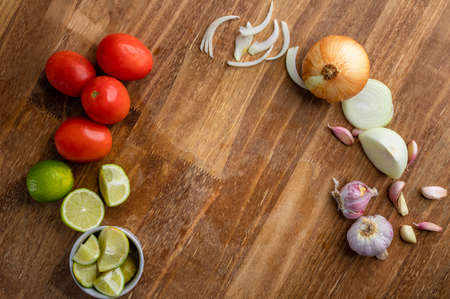 Classical vegetables, fruits and various spices arranged on a wooden table. Top view.の写真素材