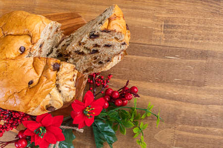 Panettone with chocolate on wooden table, traditional Italian dessert cake for Christmas. Top view. Space for text.の写真素材