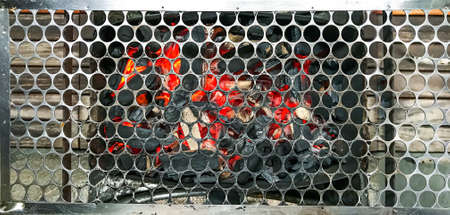 Red-hot coal at the bottom of the grill.