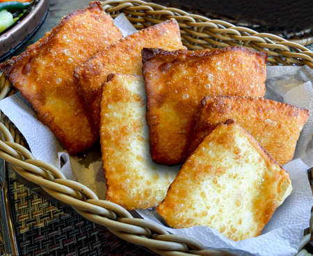 Pastel, Brazilian snack stuffed with ground meat, shrimp, cheese and crab in a straw basket.