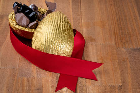 Brazilian Easter chocolate egg on wooden background.の写真素材