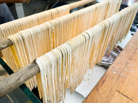spaghetti and fettuccine resting on the clothesline.の写真素材