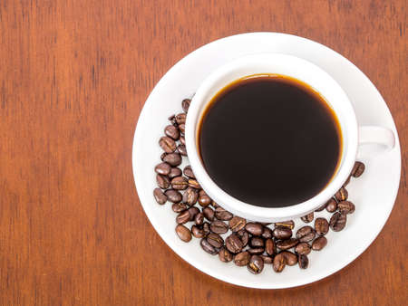 White cup coffee on wooden table backgroundの写真素材