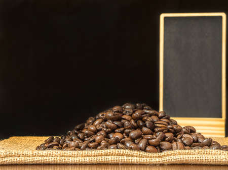 Blank menu board and coffee bean on sack with black color backgroundの写真素材