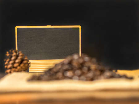 Blank menu board and coffee bean on sack with black color backgroundの写真素材