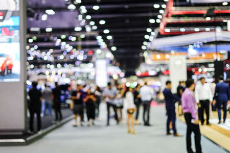 Abstract blurred background image with bokeh light of crowd people at cars exhibition showの写真素材