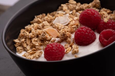 delicious breakfast with yogurt, granola and raspberriesの写真素材