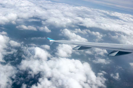 View above clouds from airplane windowの写真素材