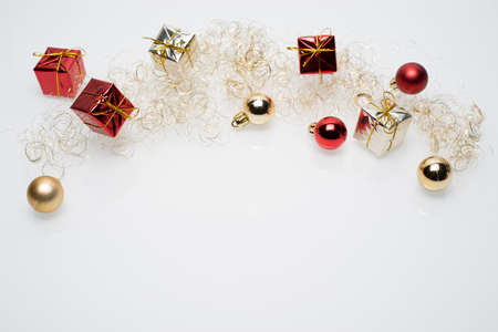 Silver and red christmas gift boxes with golden and red christmas bulbs on white backgroundの写真素材