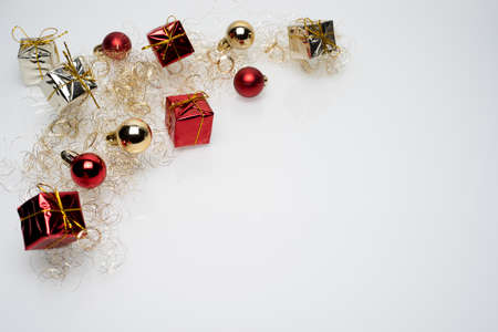 Silver and red christmas gift boxes with golden and red christmas bulbs on white backgroundの写真素材