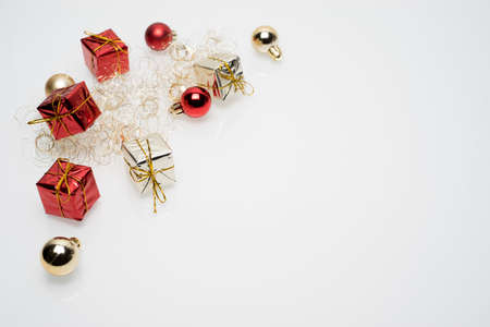 Silver and red christmas gift boxes with golden and red christmas bulbs on white backgroundの写真素材