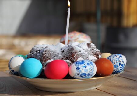 Easter cake with burning candles and eggs