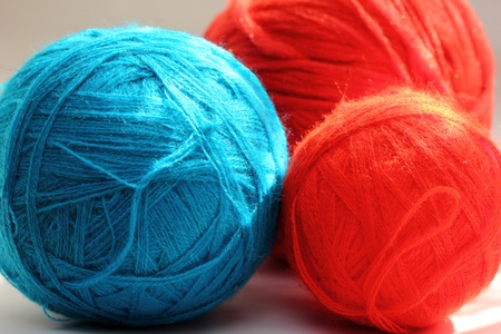 red and blue balls of yarn for needleworkの写真素材