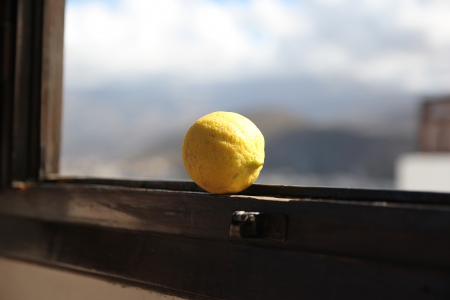 lemon lying on the window at the blue sky backgroundの写真素材