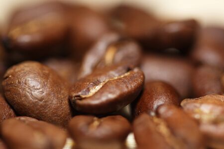 Macro shot of roasted coffee grains on a table