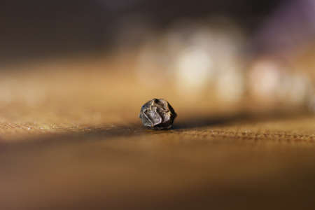 grains of black pepper on the tableの写真素材
