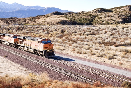 Train moving along tracks in the American desertのeditorial素材